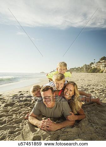 Portrait of smiling family with children (6-7, 10-11, 14-15) on beach View Large Photo Image Stock Photo - Portrait of smiling family with children (6-7, 10-11, 14-15) on beach. Fotosearch