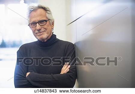 Portrait of smiling senior man standing in office corridor View Large Photo Image Stock Image - Portrait of smiling senior man standing in office corridor. Fotosearch