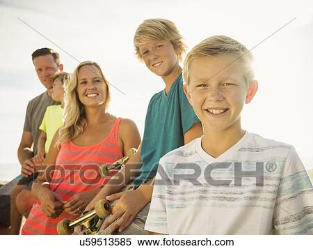 Stock Photography - Portrait of with three children (6-7, 10-11, 14-15) on vacation. Fotosearch