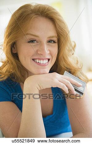 Stock Photo - Portrait of woman holding credit card. Fotosearch