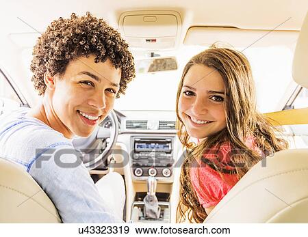 Portrait of young man and teenage girl (14-15) in car View Large Photo Image Stock Photo - Portrait of young man and teenage girl (14-15) in car. Fotosearch