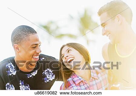 Stock Image - Portrait of young people laughing. Fotosearch