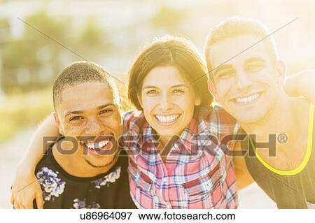 Portrait of young people with arms around each other View Large Photo Image Stock Photo - Portrait of young people with arms around each other. Fotosearch
