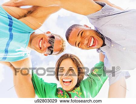 Portrait of young people with arms around each other View Large Photo Image Stock Photo - Portrait of young people with arms around each other. Fotosearch