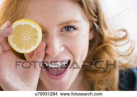 Portrait of young woman holding lemon View Large Photo Image Picture - Portrait of young woman holding lemon. Fotosearch