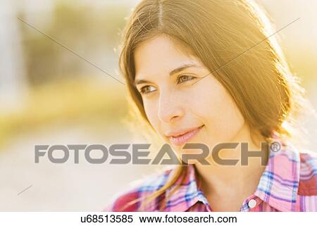 Stock Photography - Portrait of young woman in sunlight. Fotosearch