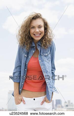 Portrait of young woman wearing denim shirt View Large Photo Image Stock Photo - Portrait of young woman wearing denim shirt. Fotosearch