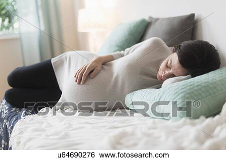 Pregnant woman in bed sleeping View Large Photo Image Stock Photograph - Pregnant woman in bed sleeping. Fotosearch