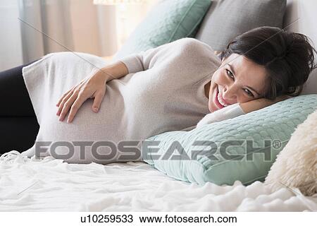 Pregnant woman in bed smiling View Large Photo Image Stock Image - Pregnant woman in bed smiling. Fotosearch