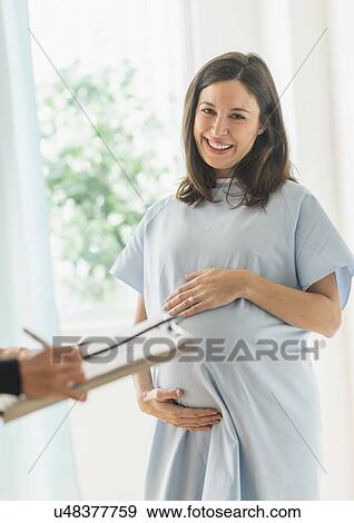 Pregnant woman in doctor's office View Large Photo Image Stock Photo - Pregnant woman in doctor's office. Fotosearch