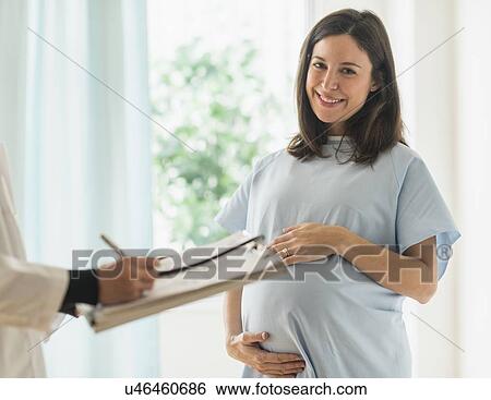 Stock Photograph - Pregnant woman in doctor's office. Fotosearch