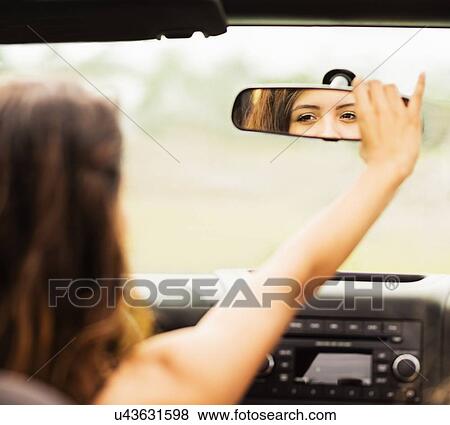 Reflection of young woman in rear view mirror View Large Photo Image Stock Photo - Reflection of young woman in rear view mirror. Fotosearch