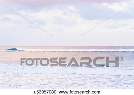 Stock Image - Scenic view of seascape at sunset. Fotosearch