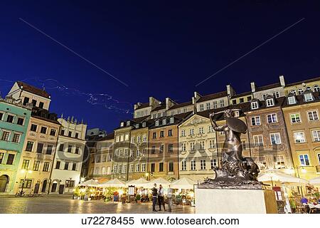 Stock Photography - Sculpture of mermaid on town square at night. Fotosearch
