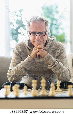 Senior man playing chess View Large Photo Image Stock Photo - Senior man playing chess. Fotosearch