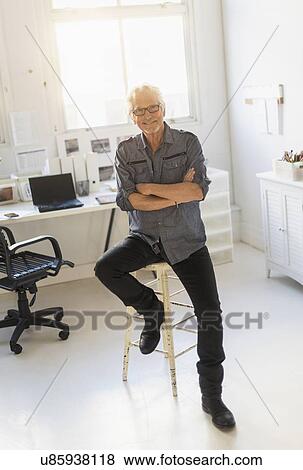 Small business owner in his office View Large Photo Image Stock Photo - Small business owner in his office. Fotosearch