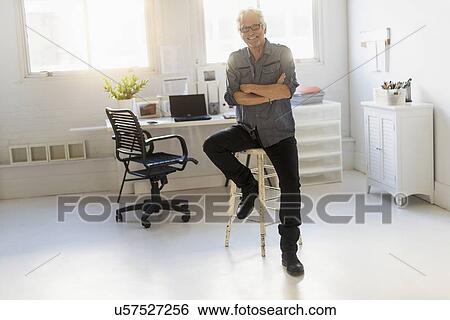 Small business owner in his office View Large Photo Image Stock Photograph - Small business owner in his office. Fotosearch