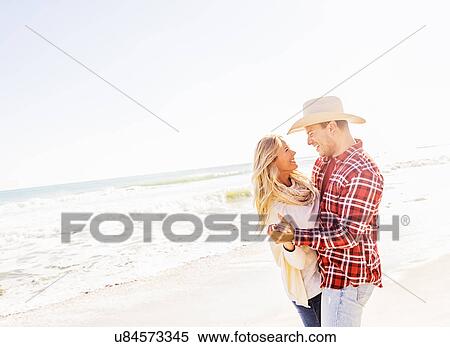 Stock Photography - Smiling couple dancing on beach. Fotosearch