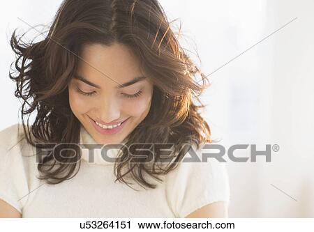 Smiling young brunette woman looking down View Large Photo Image Stock Image - Smiling young brunette woman looking down. Fotosearch