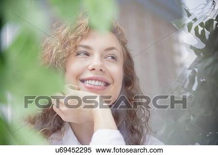 Smiling young woman daydreaming View Large Photo Image Stock Photography - Smiling young woman daydreaming. Fotosearch