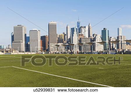 Stock Image - Soccer field and cityscape. Fotosearch