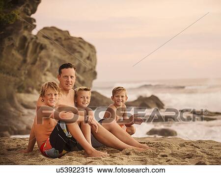 Son with three sons (6-7, 10-11, 14-15) sitting on beach View Large Photo Image Stock Photography - Son with three sons (6-7, 10-11, 14-15) sitting on beach. Fotosearch