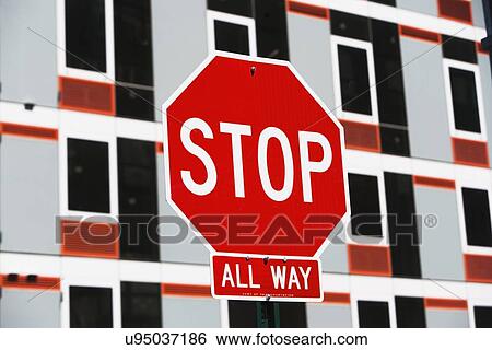 Stock Photograph - Stop sign with building in background. Fotosearch