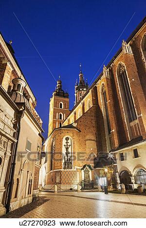 Stock Image - Street-level view of illuminated St. Barbara Church. Fotosearch