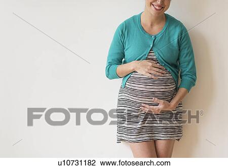 Studio shot of happy pregnant woman View Large Photo Image Stock Image - Studio shot of happy pregnant woman. Fotosearch