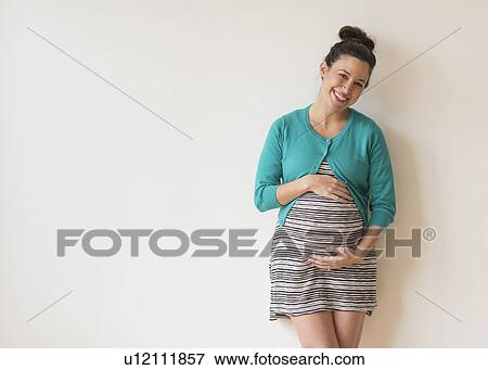 Studio shot of happy pregnant woman View Large Photo Image Stock Photo - Studio shot of happy pregnant woman. Fotosearch