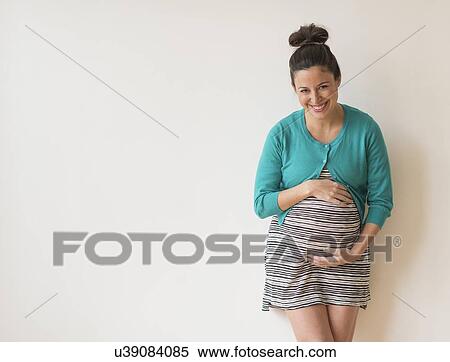 Studio shot of happy pregnant woman View Large Photo Image Stock Photography - Studio shot of happy pregnant woman. Fotosearch