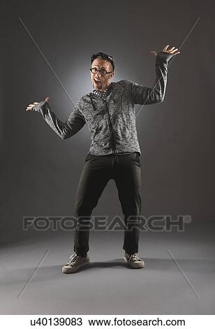 Stock Image - Studio shot of man in gray clothing. Fotosearch