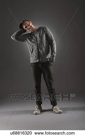 Studio shot of man in gray clothing View Large Photo Image Stock Image - Studio shot of man in gray clothing. Fotosearch