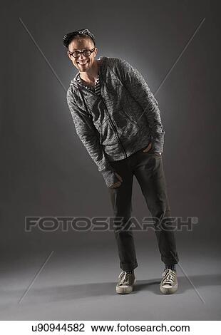Stock Image - Studio shot of man in gray clothing. Fotosearch