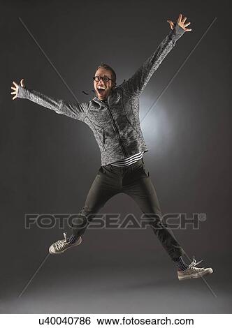 Studio shot of man jumping View Large Photo Image Stock Photograph - Studio shot of man jumping. Fotosearch