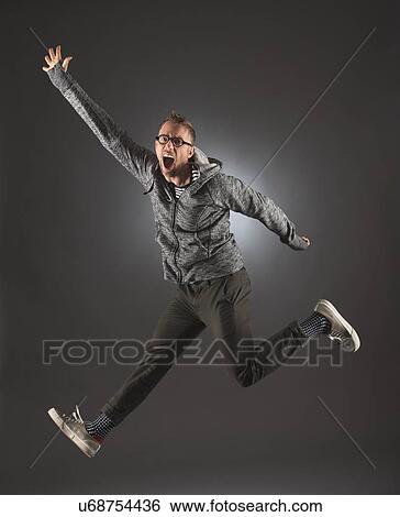 Stock Photograph - Studio shot of man jumping. Fotosearch