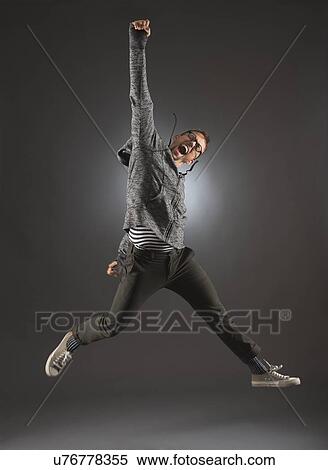 Studio shot of man jumping View Large Photo Image Stock Photography - Studio shot of man jumping. Fotosearch