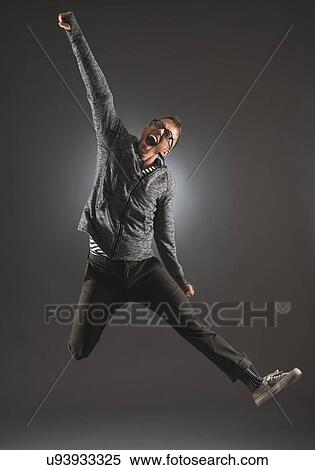 Studio shot of man jumping View Large Photo Image Stock Photography - Studio shot of man jumping. Fotosearch
