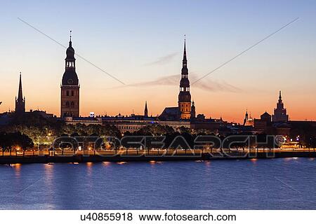 Stock Photo - View of city across River Daugava. Fotosearch