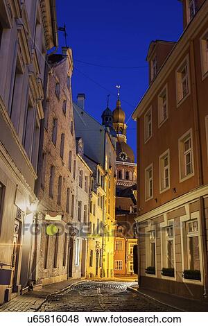 View of illuminated street in old town and Riga Cathedral at dusk View Large Photo Image Stock Photo - View of illuminated street in old town and Riga Cathedral at dusk. Fotosearch