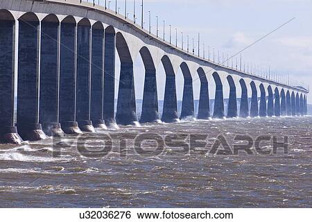 Stock Photograph - View of long concrete bridge over strait. Fotosearch