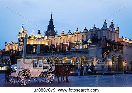 White horse carriage in front of illuminated Cloth Hall View Large Photo Image Stock Photo - White horse carriage in front of illuminated Cloth Hall. Fotosearch