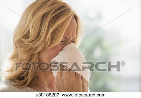 Stock Photo - Woman blowing nose. Fotosearch