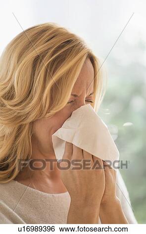 Woman blowing nose View Large Photo Image Stock Photograph - Woman blowing nose. Fotosearch