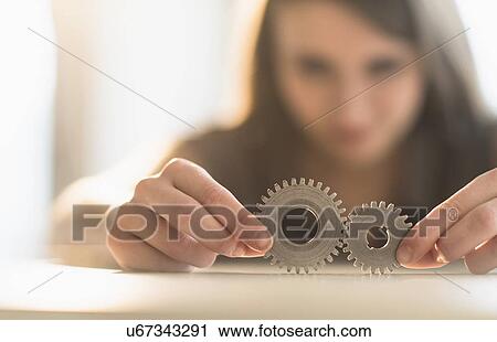Woman holding parts of engine View Large Photo Image Stock Image - Woman holding parts of engine . Fotosearch