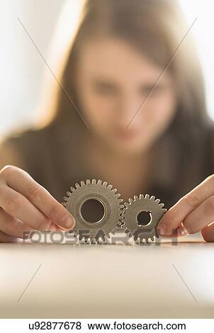 Woman holding parts of engine View Large Photo Image Stock Photo - Woman holding parts of engine . Fotosearch