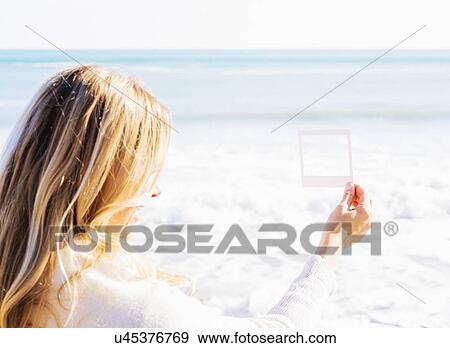 Woman holding small picture frame View Large Photo Image Stock Photo - Woman holding small picture frame. Fotosearch