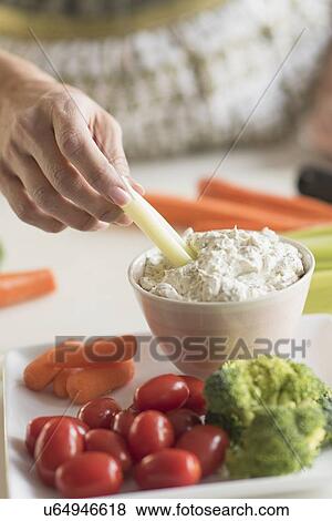 Stock Photo - Woman preparing vegetables. Fotosearch