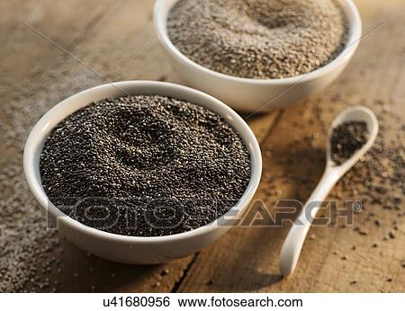 Stock Photograph - Wood bowls and spoon with seeds on wood. Fotosearch