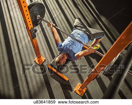 Young man bench pressing View Large Photo Image Stock Photo - Young man bench pressing. Fotosearch